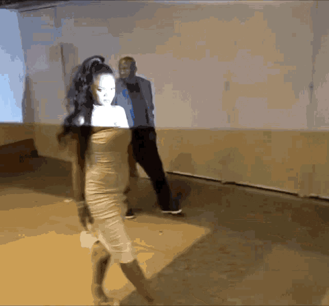 a woman in a white dress is walking down the street