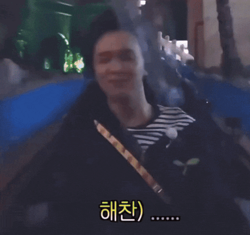 a man and woman are riding a roller coaster in the rain with chinese writing on the bottom