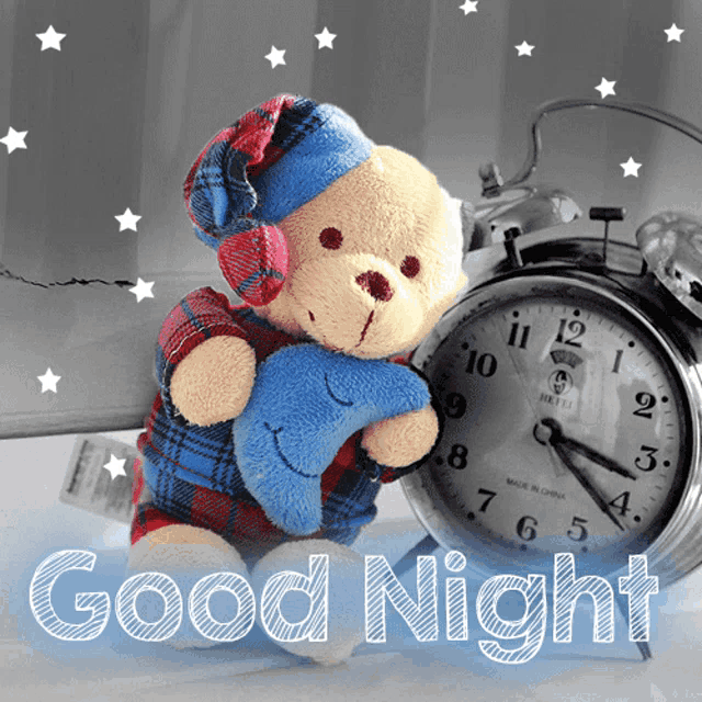 a teddy bear holding a moon next to an alarm clock with the words good night written on it