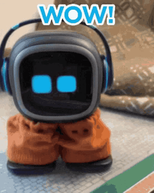 a toy robot wearing headphones says wow on the screen