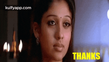 a close up of a woman 's face with the words `` thanks '' written on the bottom .