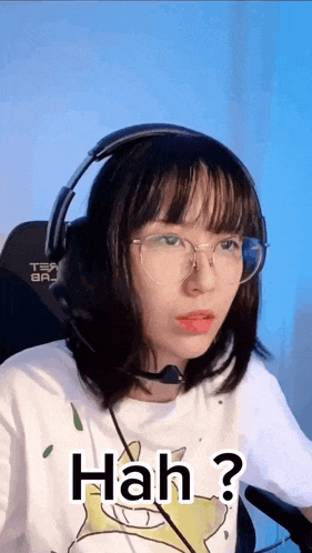 a girl wearing headphones and glasses is making a funny face and says hah ?