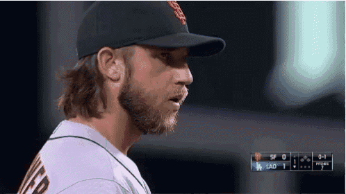 a baseball player wearing a black hat with a sf logo on it