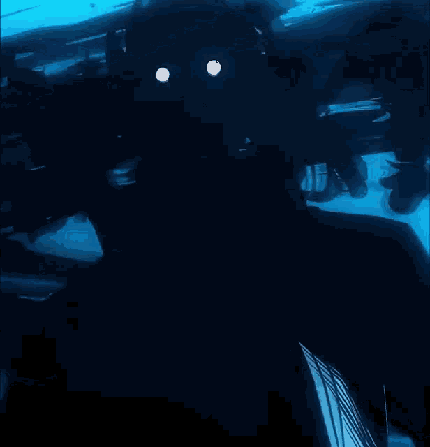 a silhouette of a person in the water with a white eye