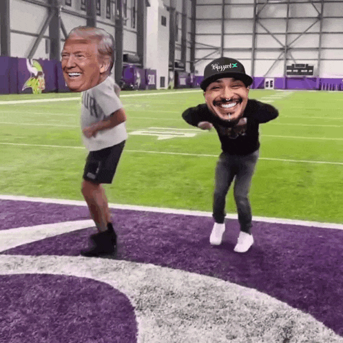 two men are dancing on a football field with one wearing a hat that says eagles on it