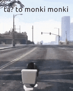 a toilet is sitting on the side of the road with the words ta to monki monki