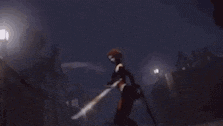 a woman with red hair is standing in a dark room holding a gun .