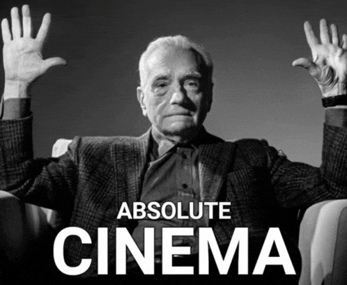 a man is sitting in a chair with his hands in the air and the words absolute cinema below him
