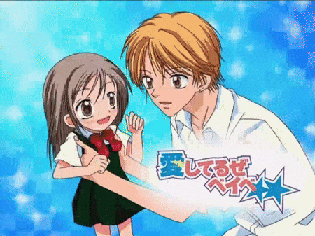a boy and a girl are standing next to each other with a sign that says " 愛し てる ぜ "