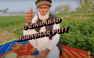 a man with a beard is giving a thumbs up with the words o zindabad mubashar putt above him