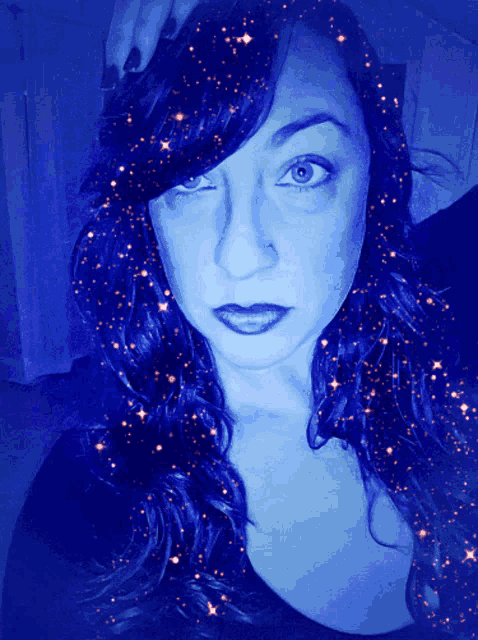 a woman 's face is surrounded by stars in a dark blue background