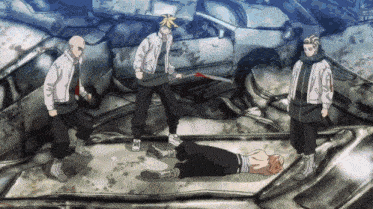 a group of men are standing around a man laying on the ground holding a knife .