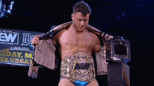 a wrestler is standing in front of a sign that says sunday