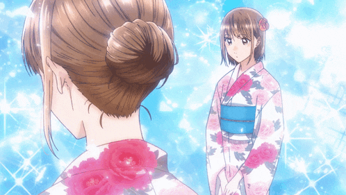 a woman in a pink and white floral kimono is standing next to another woman