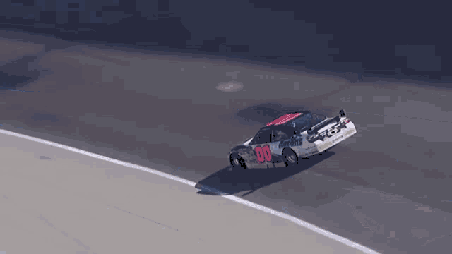 a race car with the number 00 on it is going around a curve