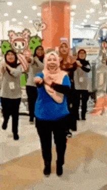a group of women are dancing together in a store .