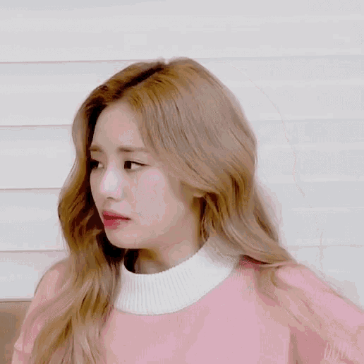 a woman in a pink sweater with the word dude on the bottom