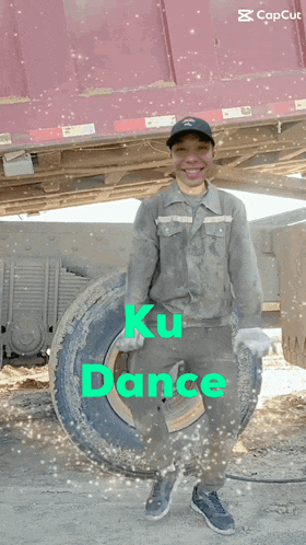a man is standing in front of a truck with the words ku dance written on the bottom