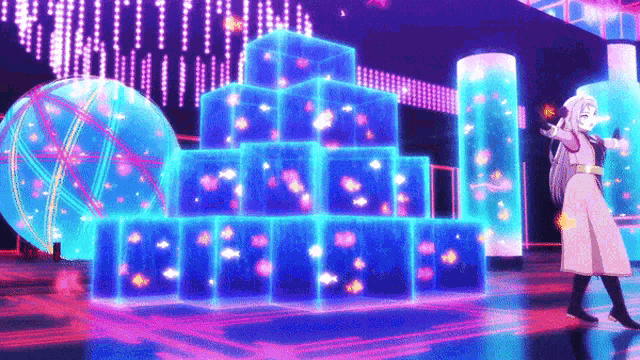 a woman in a pink coat is standing in front of a pyramid of blue boxes