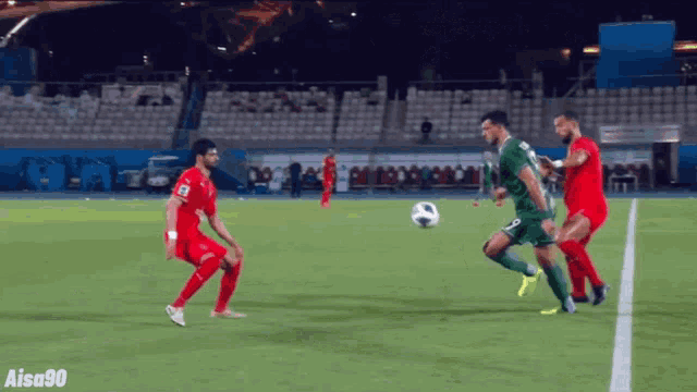a soccer game is being played on a field with aisa90 written on the bottom