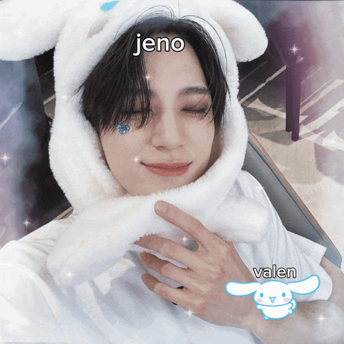 a person wearing a white bunny hat with jeno and valen written on it