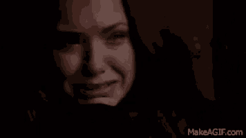 a close up of a woman crying with a tear running down her face .