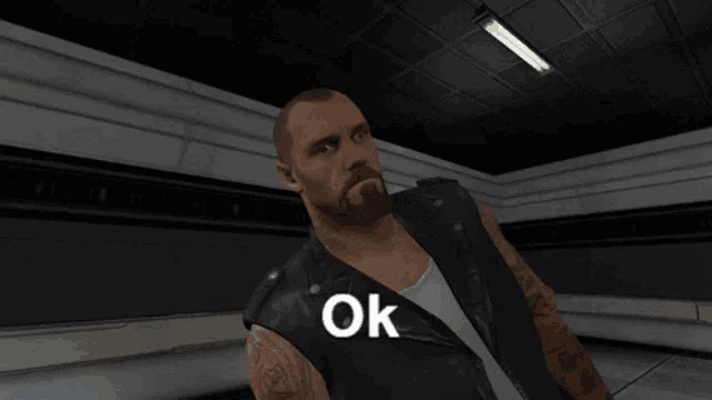 a man with a beard is wearing a black leather vest that says ok