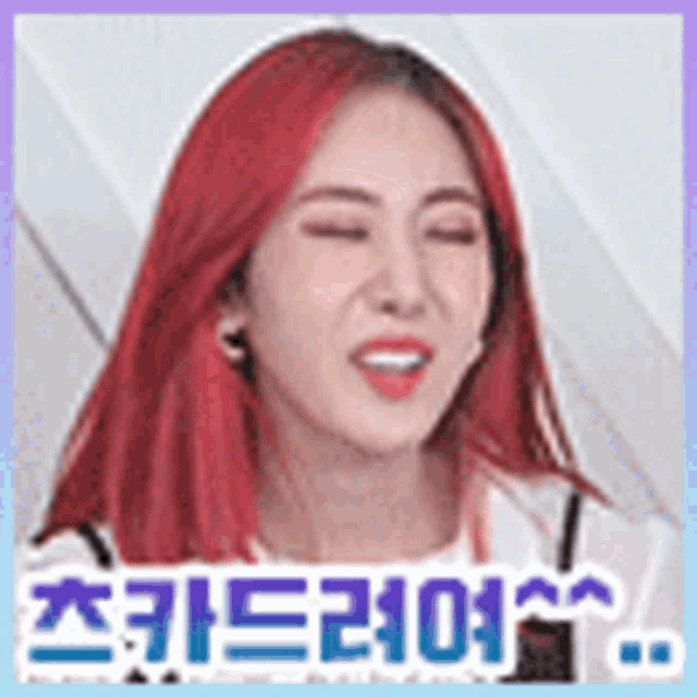 a woman with red hair is making a funny face with her eyes closed and her tongue sticking out .