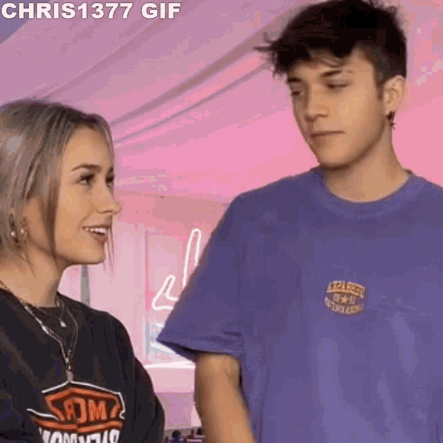 a man and a woman are standing next to each other and smiling .