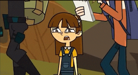 a girl in overalls is sitting in front of a man holding a notebook .