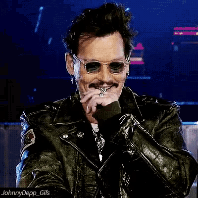 a man wearing sunglasses and a leather jacket has the hashtag johnnydepp gifs on the bottom
