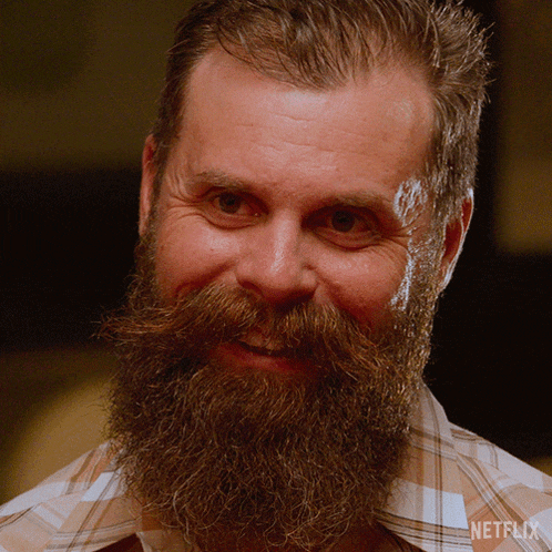 a man with a beard and mustache is wearing a plaid shirt that says netflix on the bottom