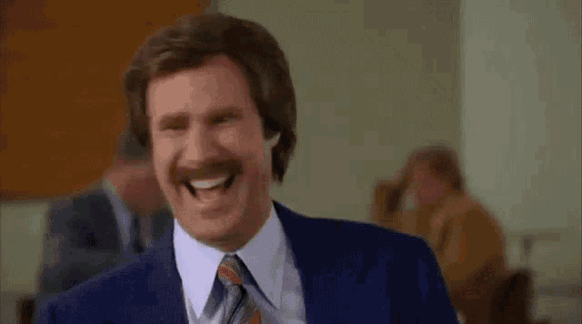 a man in a suit and tie is saying we are laughing