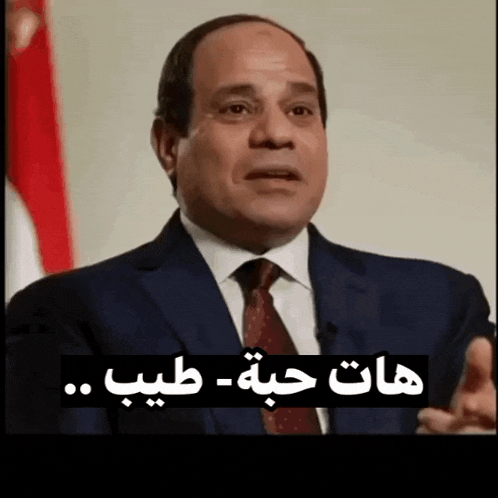 a man in a suit and tie is speaking in a foreign language