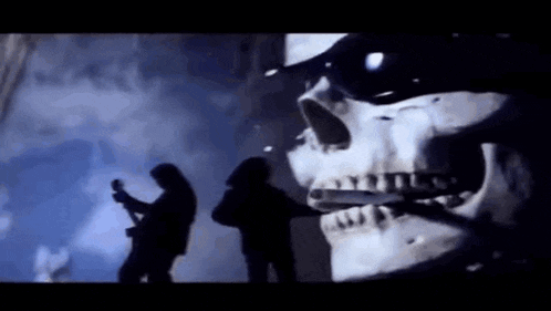 a man is playing a guitar in front of a skeleton .