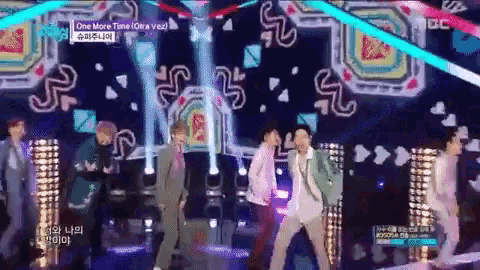 a group of men are dancing on a stage with a sign that says one more time on it
