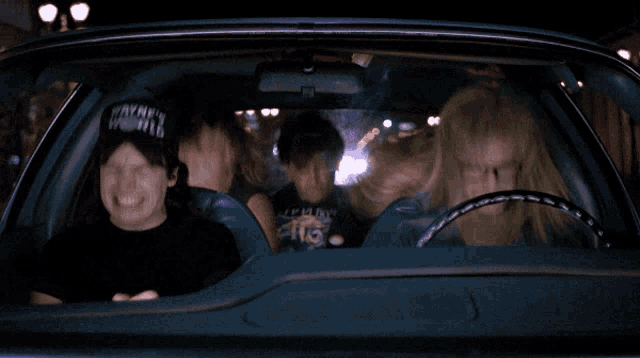 a group of people are sitting in a car and one of them is wearing a shirt that says zephyrs