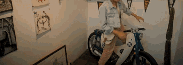 a woman is standing next to a motorcycle with a sticker on the front that says r2