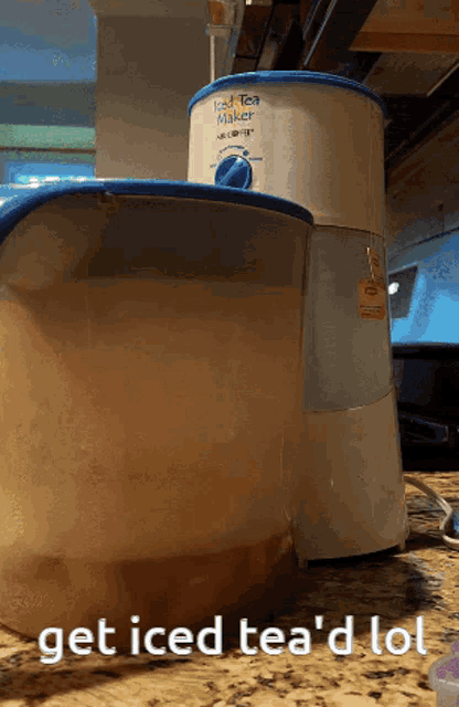 a iced tea maker sits next to a pitcher of iced tea