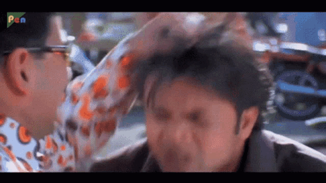 a man is slapping another man 's head in a movie .