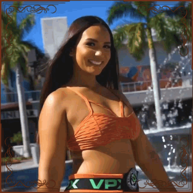 a woman in a bikini is wearing a belt that says ' vpx ' on it