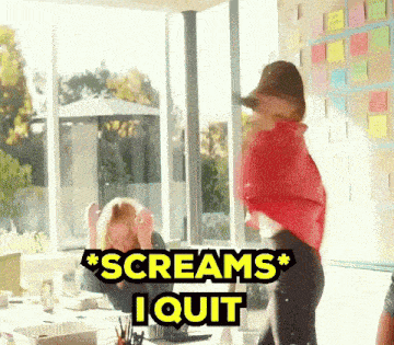 a woman in a red shirt screams i quit in front of a window