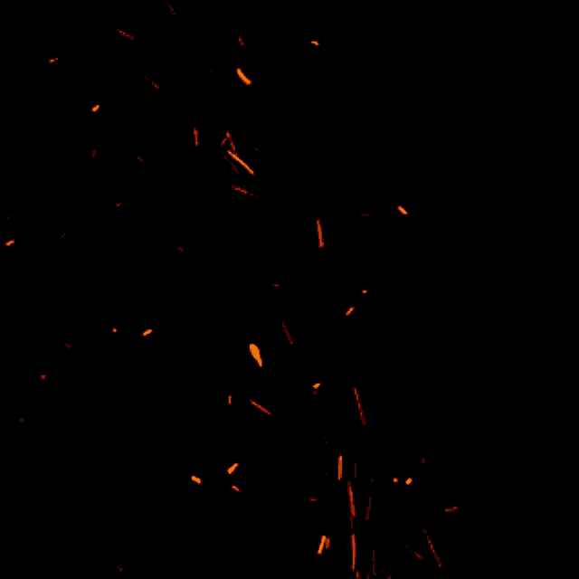 a black background with a lot of orange sparkles flying in the air