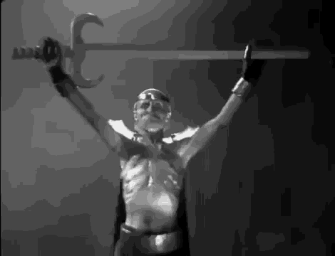 a black and white photo of a man with a sword