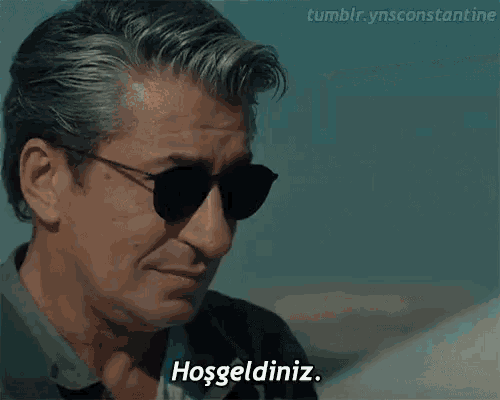 a man wearing sunglasses says hoşgeldiniz in a video