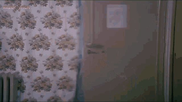 a floral curtain is hanging on a wall with the words arzu film written on the bottom