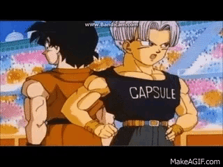 goku and trunks from dragon ball z are standing next to each other . goku is wearing a capsule shirt .