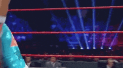 a man in a superhero costume is wrestling in a wrestling ring .