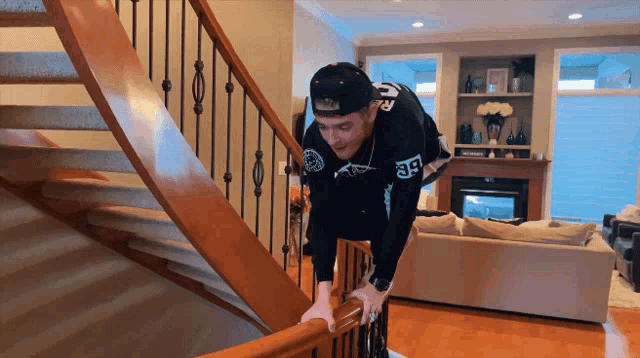 a man wearing a jersey with the number 38 on it climbs a staircase
