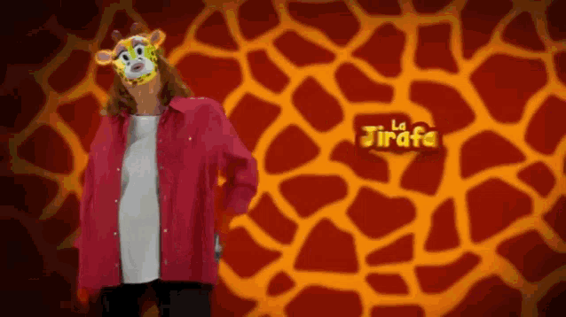 a woman wearing a giraffe mask is standing in front of a giraffe print background